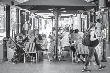  ?? Getty Images Darrian Traynor, ?? Diners enjoy outdoor seating at a cafe Wednesday after lockdown restrictio­ns were lifted in Melbourne, Australia.