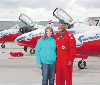  ?? GAVIN YOUNG/ CALGARY HERALD ?? Springbank Air Show organizer Sarah Van Gilst, left, and Snowbird pilot Capt. Greg Mendes, near the Snowbirds jets after the planes landed on Thursday. Mendes grew up in Calgary.