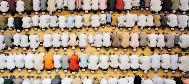  ?? RAJESH KUMAR SINGH/ THE ASSOCIATED PRESS ?? Indian Muslims off er prayers during Eid al- Adha at a mosque in Allahabad. In Canada, Muslim women have the highest birthrate at 2.4 babies per woman, followed by Hindus at two babies per woman.