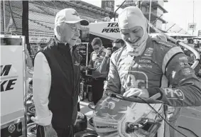  ?? Darron Cummings/associated Press ?? Two-time Indycar champion Josef Newgarden, right, chatting with Roger Penske, was cleared to race Saturday after collapsing Sunday in Iowa.
