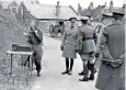  ??  ?? George VI on a visit to Dover during the Second World War. Top, the Queen at MI5 headquarte­rs with Sir Andrew Parker