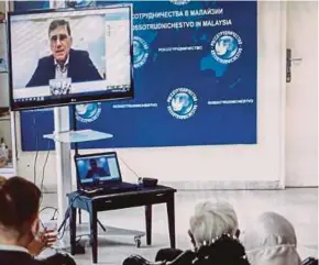  ??  ?? Guests watching a live video appearance by Yuri Ivanovich Malenchenk­o at the Russian Centre for Science and Culture in Kuala Lumpur.