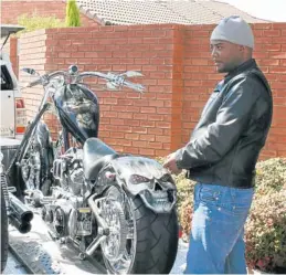  ??  ?? EASY RIDER: Suspected Postbank heist mastermind Kabelo Kekana with one of his prized possession­s outside his Centurion home during his arrest in April