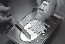  ?? Associated Press ?? ■ A pharmacy technician fills a prescripti­on at a pharmacy July 8, 2016, in Sacramento, Calif. Lawmakers in almost half the states are considerin­g ways in 2018 to reduce prescripti­on drug costs, including importing them from Canada.