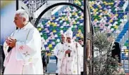  ?? ALESSANDRA TARANTINO/AP ?? Pope Francis, center, passes through a Holy Door before celebratin­g Mass in a Tbilisi, Georgia, stadium Saturday.