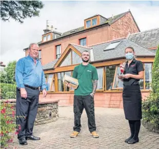  ??  ?? Owner Alan Bannerman, left, outside the Red House Hotel in Coupar Angus with members of his staff.