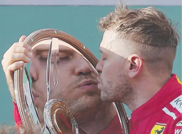  ?? Picture: AP PHOTO ?? VICTOR: Ferrari driver Sebastian Vettel kisses his trophy after winning the first race of the season at the Australian Formula One Grand Prix in Melbourne.