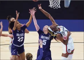  ?? Eric Gay / Associated Press ?? UConn forward Aaliyah Edwards (3) battles High Point guard Chyna McMichel (22) and High Point guard Claire Wyatt (5) for a rebound during the first half.