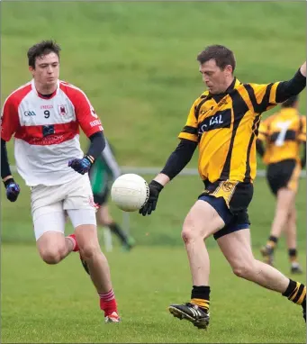  ??  ?? Charlevill­e’s Gavin Kelleher can’t get close enough to stop Clyda Rovers’ Gavin Carey sending a ball in to his full forward line during the clash of the sides in the North Cork Junior A Championsh­ip last weekend.
Photo by Eric Barry