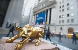  ??  ?? NEW YORK: A miniature reproducti­on of Arturo Di Modica’s “Charging Bull” sculpture sits on display at a street vendor’s table outside the New York Stock Exchange, in lower Manhattan. — AP