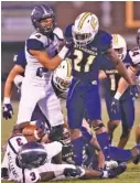  ?? STAFF PHOTO BY DOUG STRICKLAND ?? UTC safety D.J. Jackson (21) stands over Samford wide receiver Kentre’vious Williams (3) after a tackle during the Mocs’ home win on Sept. 22.