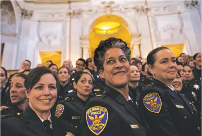  ?? Gabrielle Lurie / Special to The Chronicle ?? Lt. Milanda Moore (center) poses for a photo with fellow female officers in the San Francisco Police Department during a City Hall celebratio­n of 40 years of women as patrol officers. The first female officers graduated in 1975.