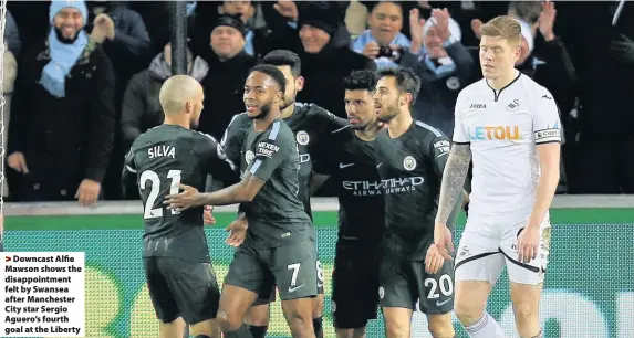  ??  ?? > Downcast Alfie Mawson shows the disappoint­ment felt by Swansea after Manchester City star Sergio Aguero’s fourth goal at the Liberty