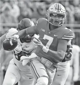  ?? RICK OSENTOSKI/USA TODAY SPORTS ?? Ohio State quarterbac­k C.J. Stroud scrambles against Michigan State on Saturday in Columbus, Ohio.