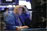  ??  ?? A trader works on the floor of the New York Stock Exchange on Monday. [AP PHOTO]