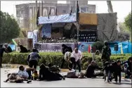  ?? AFP ?? Men, women, and children lie on ground and some seek cover at the scene of an attack on a military parade in the southweste­rn Iranian city of Ahvaz on September 22, 2018.