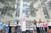  ?? AP ?? People hold signs at the embassy of Saudi Arabia in Washington during a protest about the disappeara­nce of Jamal Khashoggi.