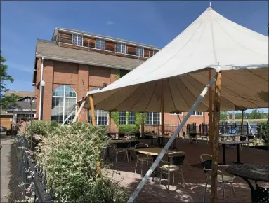  ?? TANIA BARRICKLO — DAILY FREEMAN ?? Tables and chairs are set up under an outdoor tent at Ole Savannah Southern Table & Bar in Downtown Kingston, N.Y., on Monday, June 8, 2020.