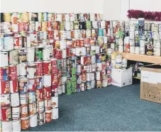  ?? ?? Some of the 3,000 tins donated by pupils and staff at Southmoor Academy.