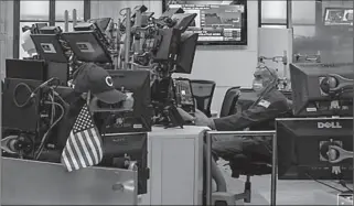  ?? NEW YORK
-AP ?? A staff member works at a trader station as preparatio­ns are made for the return to trading at the New York Stock Exchange (NYSE).