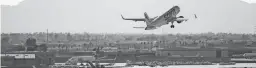  ?? PATRICK BREEN/THE REPUBLIC ?? A plane takes off at Phoenix Sky Harbor Airport.