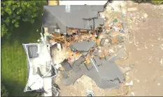  ?? Associated Press photo ?? Debris is strewn about after a sinkhole damaged two homes in Land O' Lakes, Fla. on Friday.