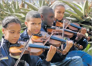  ?? Picture: FREDLIN ADRIAAN ?? TUNING UP: Among the 13 young violinists from Booysen Park Primary School who will visit Cape Town through the Eastern Cape Philharmon­ic Orchestra developmen­t programme are, from left, Angelique Warnicker, 12, Dylan Brown, 12, Somila Mancoba, 11, and...