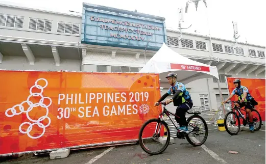  ??  ?? SECURITY AT THE GAMES – Members of the Manila Police use bicycles in going around the Rizal Memorial Stadium in Manila to secure the place, one of the key venues of the 30th Southeast Asian Games that the Philippine­s is hosting this week. (Ali Vicoy)