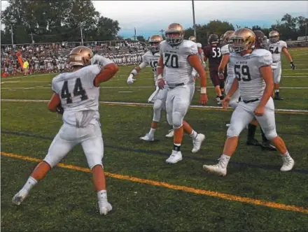  ?? PETE BANNAN — DIGITAL FIRST MEDIA ?? West Chester Rustin’s Owen Walsh celebrates a first quarter touchdown against West Chester Henderson with teammates RJ Cleveland