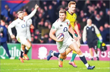  ?? BEN STANSALL/AFP ?? England fly-half Owen Farrell scores a try during the internatio­nal rugby union Test match between England and Australia at Twickenham stadium in southwest London on Saturday. Coach Eddie Jones is buoyant after England’s 37-18 victory.