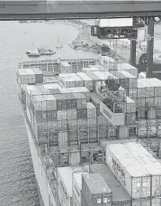  ?? James Nielsen / Houston Chronicle ?? A crane unloads a container from a ship at the Bayport Container Terminal this month.