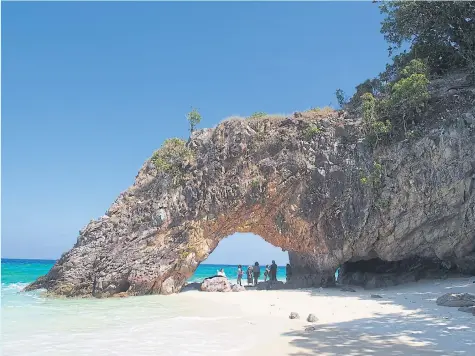  ?? PHOTO BY SATUN GEOPARK/RATH JITRATTANA ?? The spectacula­r natural arch of Ko Khai, often referred to as ‘Lover’s Gate’, is used as a tourism symbol for Satun province. Couples who pass through the arch will remain in love forever, so the legend goes.