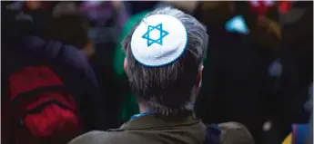 ?? MARKUS SCHREIBER/ AP ?? A man wears a Jewish skullcap at a demonstrat­ion against an anti- Semitic attack in Berlin in April.