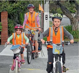  ?? PHOTO: FAIRFAX NZ ?? Lower Hutt’s Jo Clendon – with her children Kiri, 6, and Max, 9 – has petitioned Parliament for a law change that would allow children under 12, and their supervisin­g parents, to cycle on footpaths.