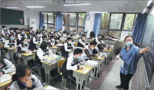 ?? CHEN XUEZI / FOR CHINA DAILY ?? Senior students at a high school in Wuhan, Hubei province, return to school in May to prepare for the gaokao, the national college entrance exam. Schools in the city were closed as a result of the COVID-19 pandemic.