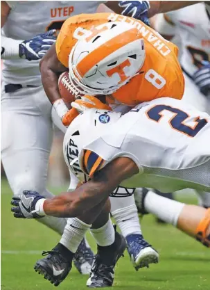  ?? STAFF PHOTO BY ROBIN RUDD ?? Tennessee’s Ty Chandler (8) runs through the tackle attempt of UTEP’s Michael Lewis for a big gain during the Vols’ 24-0 win Saturday at Neyland Stadium. Chandler gained 158 yards on a dozen carries.