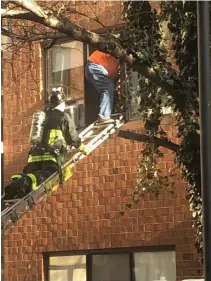  ?? PHOTOS COURTESY OF BOSTON FIRE DEPARTMENT ?? EVACUATION: A Boston firefighte­r guides one of the residents of a Brighton senior housing complex down a ladder during a four-alarm fire on Thursday. An elderly woman, below, is helped by EMS.