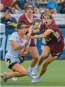  ?? KARL MERTON FERRON/BALTIMORE SUN ?? Maryland attacker Libby May, left, tumbles after exchanging contact with Boston College defender Melanie Welch (13) while Boston College defender Sydney Scales watches during an NCAA Division I women’s lacrosse semifinal Friday at Johns Hopkins’ Homewood Field.