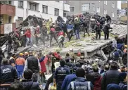  ?? DHA VIA AP ?? Rescue workers and others try to remove debris of an eight-story building that collapsed in Istanbul on Wednesday, killing at least one person and trapping several others inside the rubble.