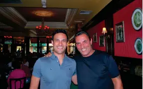  ?? BRAD BALUKJIAN VIA AP ?? In this July 18, 2015, photo provided by Brad Balukjian, Brad Balukjian, left, stands with former major league outfielder Lee Mazzilli in Rye, N.Y. Balukjian tore open a pack of 1986 Topps baseball cards, chewed the stale, brittle bubblegum and then planned a journey most sports fans could only dream about.