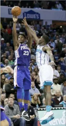  ?? CHUCK BURTON — THE ASSOCIATED PRESS ?? The Sixers’ Jimmy Butler (23) rises for the gamewinnin­g shot over Charlotte’s Dwayne Bacon (7) in overtime in Charlotte, N.C., Saturday.