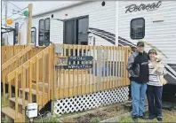  ?? NIKKI SULLIVAN/CAPE BRETON POST ?? Eddie and Wendy Odo stand with their dog Teikah outside their trailer at Lakeview Campground in Catalone.