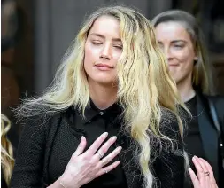  ?? AP ?? Actor Johnny Depp waves as he leaves after the end of the trial at the High Court in London yesterday. Depp’s former wife Amber Heard, right, speaks outside the court.