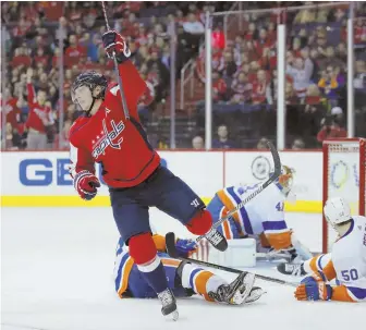  ?? AP PHOTO ?? SWEET FINISH: Capitals center Nicklas Backstrom puts the puck past Islanders defenseman Adam Pelech (50) and goalie Jaroslav Halak for a goal last night.