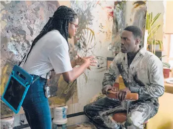  ?? PARRISH LEWIS/UNIVERSAL PICTURES AND MGM PICTURES ?? Nia DaCosta with Yahya Abdul-Mateen II on the set of“Candyman.”