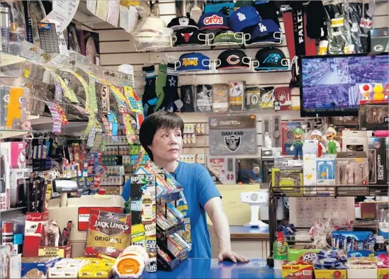  ?? Rick Loomis Los Angeles Times ?? SUE KIM and her husband run Biky’s Market, a Boyle Heights convenienc­e store that’s been in the family for decades. The Kims are close with many of their customers, offering advice for issues that sometimes “sound like soap operas,” Kim said. Lately,...