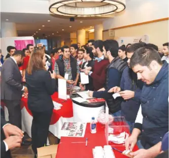  ??  ?? Students are seen at the Gulf Bank booth at the 2015 NUKS-USA conference.