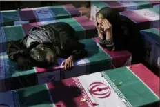  ?? Vahid Salemi/Associated Press ?? Mourners weep on Friday over the flag-draped coffin of their loved one who was killed in Wednesday’s bomb explosion, during a funeral ceremony in the Iranian city of Kerman about 510 miles southeast of Tehran.