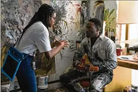  ?? PARRISH LEWIS/UNIVERSAL PICTURES AND MGM PICTURES VIA AP ?? Director Nia Dacosta (left) talks with actor Yahya Abdul-mateen II on the set of “Candyman.” The film, also written by Dacosta, is a sequel to the 1992 horror classic of the same name.