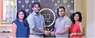  ??  ?? RV Fashion Managing Director Dinesh Fernando issuing the loyalty card to a customer in the presence of RV Fashion Director Dhesha Fernando (extreme left)